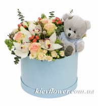 Flowers in a box with a teddy bear
